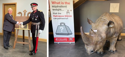 Royston Morgan shaking hands with His Majesty's Lord-Lieutenant of Staffordshire Mr Ian Dudson, CBE KStJ and Rhino replica next to pop up banner